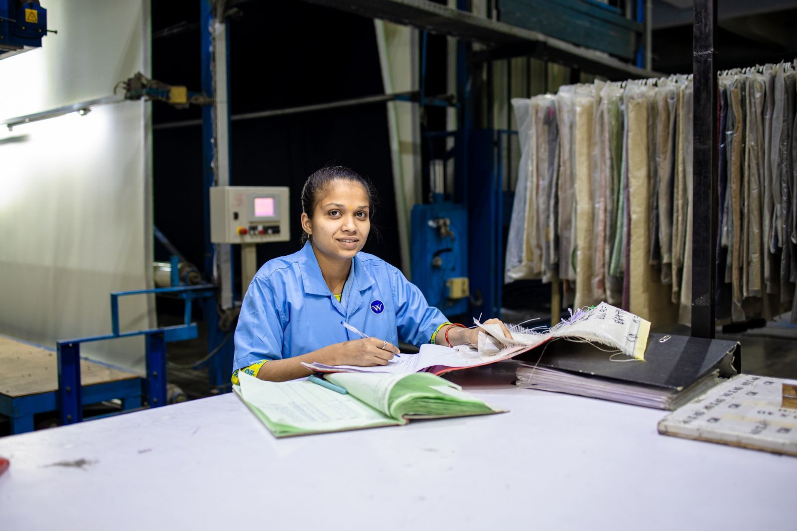 A handwritten register on a factory desk